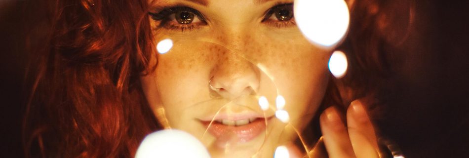 photography of a woman holding lights