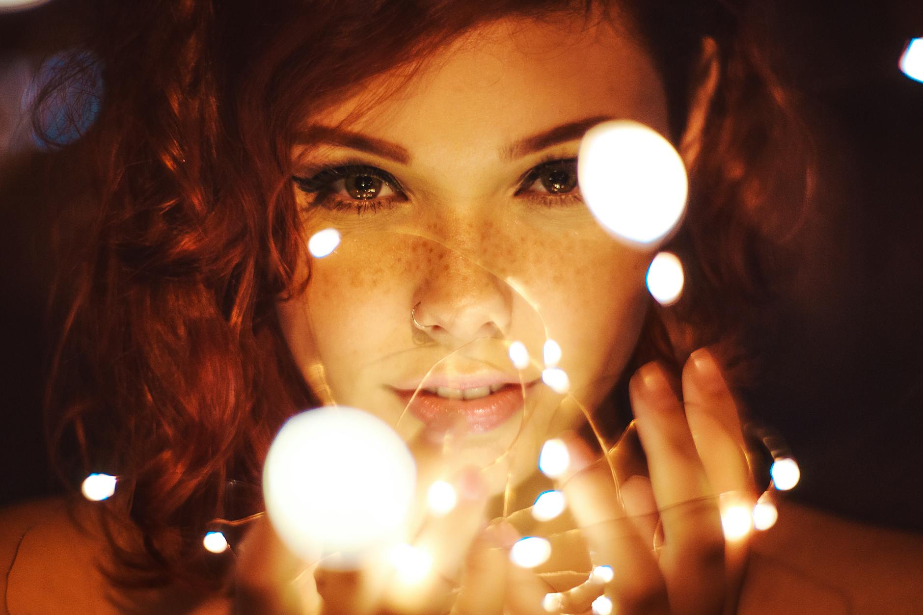 photography of a woman holding lights